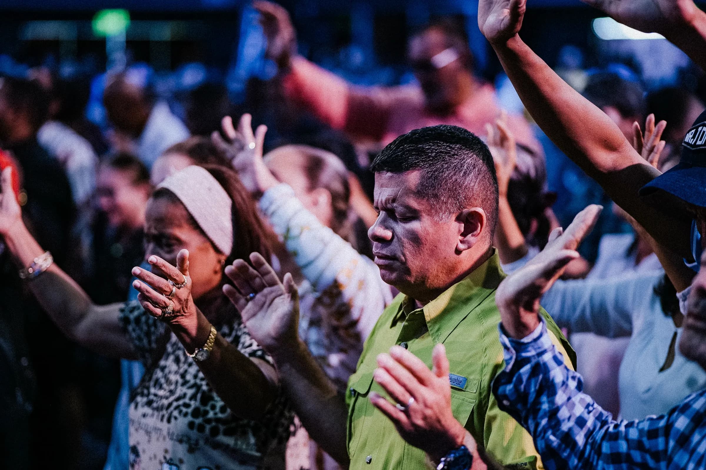 Congregation worshipping together with raised hands during a church service
